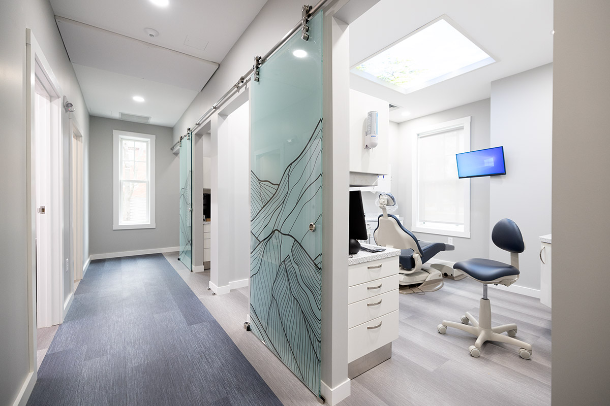 Interior of one of the Williston Road Family Dental patient rooms as seen from the hallway