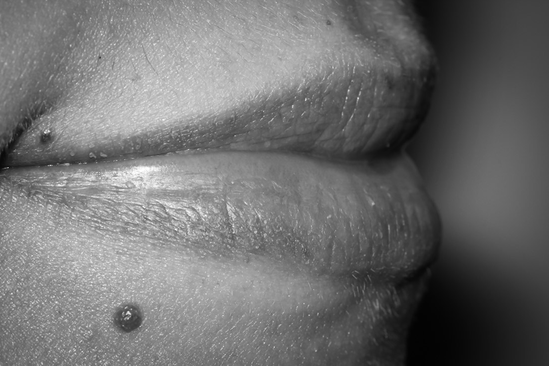 Black and white side view close up of a person's lips